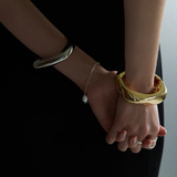 Gold-colored hinged bangle bracelet