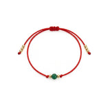 Bransoletka na sznurku z turkusem, wykończona kuleczkami pozłacanymi 24k złotem